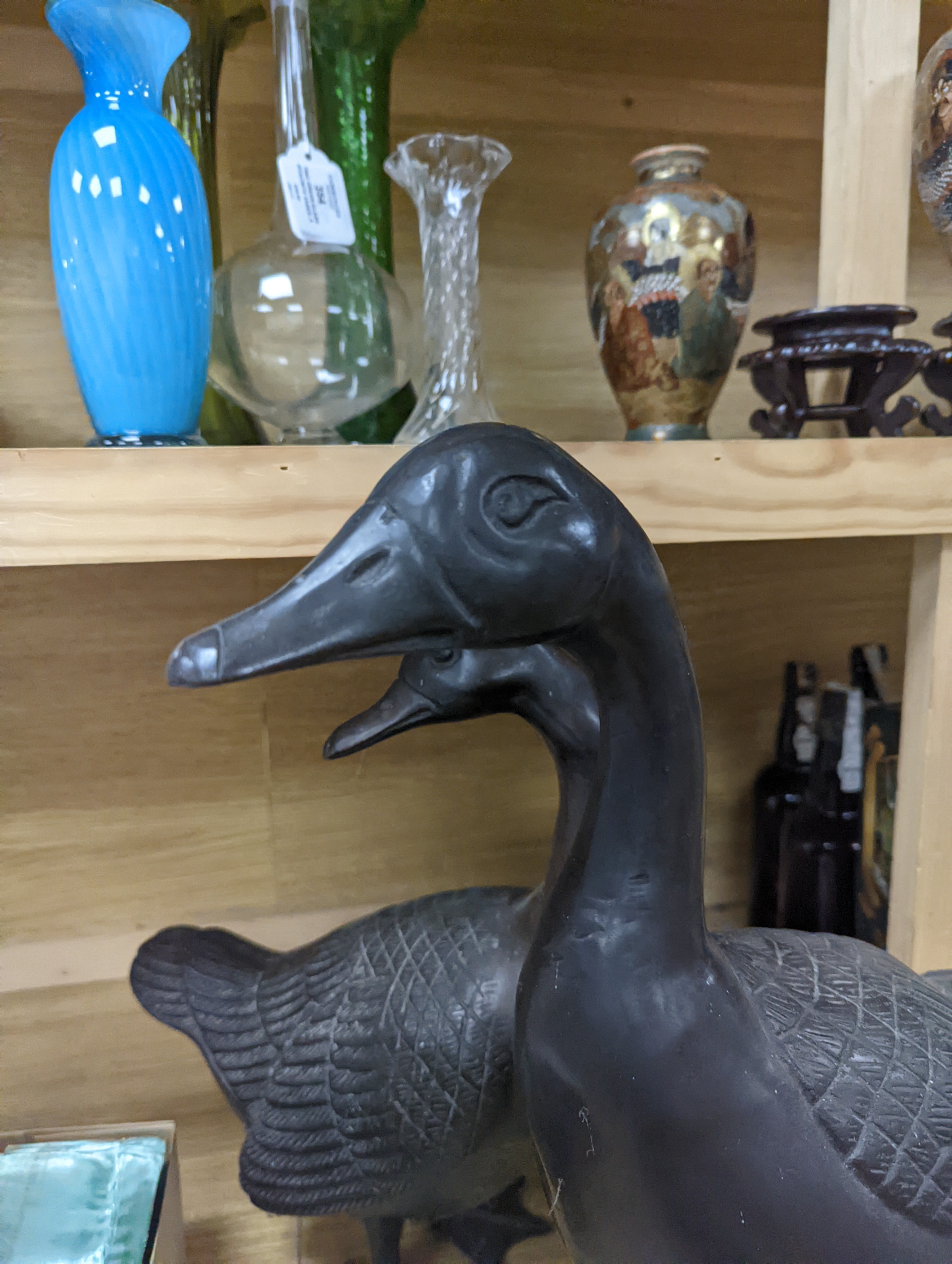 A pair of modern Chinese bronze models of geese, largest 48cm
